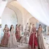 Keep it dreamy and classic with the best DeemasFashion reception wear! The handsome deep red outfit with blouse and lehenga is gracefully embellished with silver embroidery that gives you a head-turning appearance on the wedding day. The blouse is enhanced with tilla, dabka, kora, Kundan and crystals. The round neckline of the blouse makes this glamorous attire an epitome of royalty and grace. Luxury designs on half sleeves add super beauty to the outfit. It is organized with a lehenga adorned with embroidery to make your day charming. Finish this outfit with a dupatta embellished with four-sided borders and which is sprinkled with sequins all over.