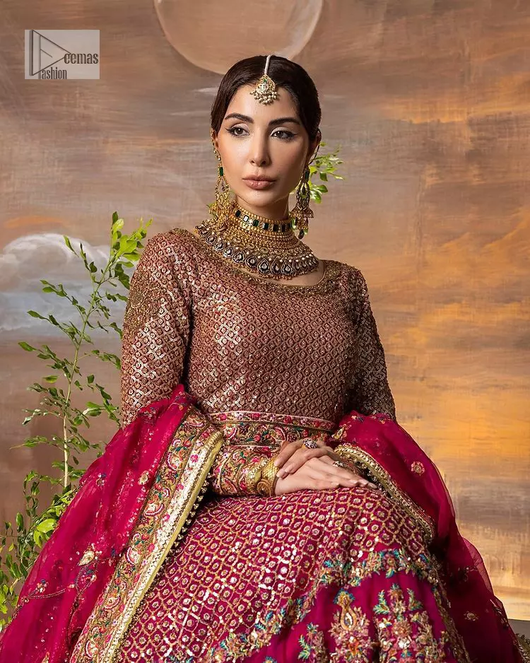 Experience the true essence of reception wear in alluring attires from DeemasFashion. The host pink pishwas is decorated with multiple colour embroidery which is handsomely enhanced with tilla, dabka, kora, Kundan and the real magic of Zardozi to make this masterpiece unique and charming. The finishing of boat shape neckline enhances the beauty of the attire. Furthermore, the full sleeves of the pishwas are a perfectly charming choice to pair with a Pishwas. It is coordinated with a jamawar lehenga whose border is adorned with beautiful embroidery. Complete this article with a dupatta framed with four-sided embellished borders and sequins sprayed all over.

