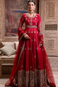 The traditional style is the new thing in the market. The stunning pishwas in the deep red shade is an eye-catching attire that gives you your desired dreamy appearance on your Big day. Beautiful work of zardozi, tilla, dabka, kora, Kundan, pearls, and beads make this attire an epitome of glamour and royalty. Embellished borders, as well as the bodice, gives an enchanting touch to this pishwas. Further, the round neckline of the outfit gives a royal touch. Further, fancy floral motifs are also adorned on the sleeves of this reception wear. It is organized with a dupatta framed with a four-sided border and sparkling tiny floral motifs all over.