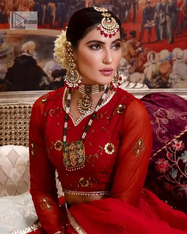 Statement suiting in red. This red blouse comes with a lehenga and dupatta in premium fabric quality. The blouse is beautifully decorated with fine embroidery work accompanied by iridescent sequins, tilla, dabka, kora and Zardozi. Furthermore, beautiful artistry on the neckline is highlighted with golden embroidery accompanied by cutwork counting more to the elegance of this luxurious attire. It is organized with a flared lehenga in the same colour. This embroidered lehenga comes is very neatly stitched and decorated with lavish embroidery and minimal floral motifs making this dreamy attire look heavenly and your ultimate priority. Complete this reception wear with a dupatta framed with four-sided embellished borders that is your favourite statement on your big day.