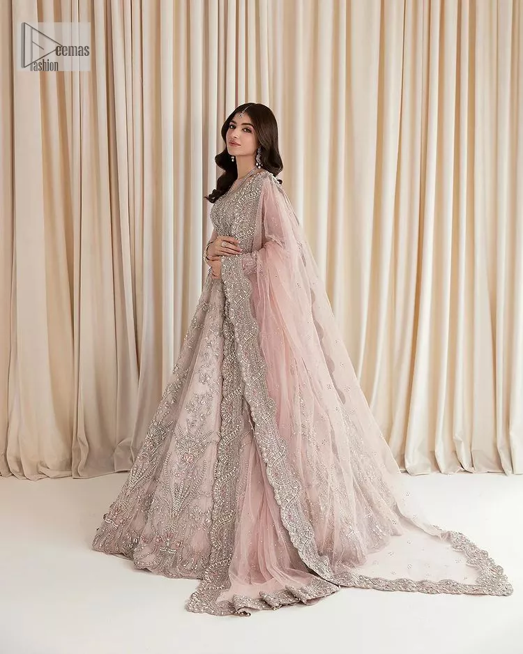Rose Pink, is the colour of confidence on your big day. The blouse in the rose pink shade is embellished with intricate designs, silverwork, and fine details. The V shape neckline and full sleeves look perfect with the lehenga. Beautiful details of crystals, tilla, dabka, kora, stones, and dabka give a perfect finishing look to the following blouse. It is organized with a lehenga which is heavily adorned with silver embroidery to add more charm and beauty to the outfit. Complete this outfit with a dupatta framed with four-sided borders that gives an elegant look to the gorgeous bride.