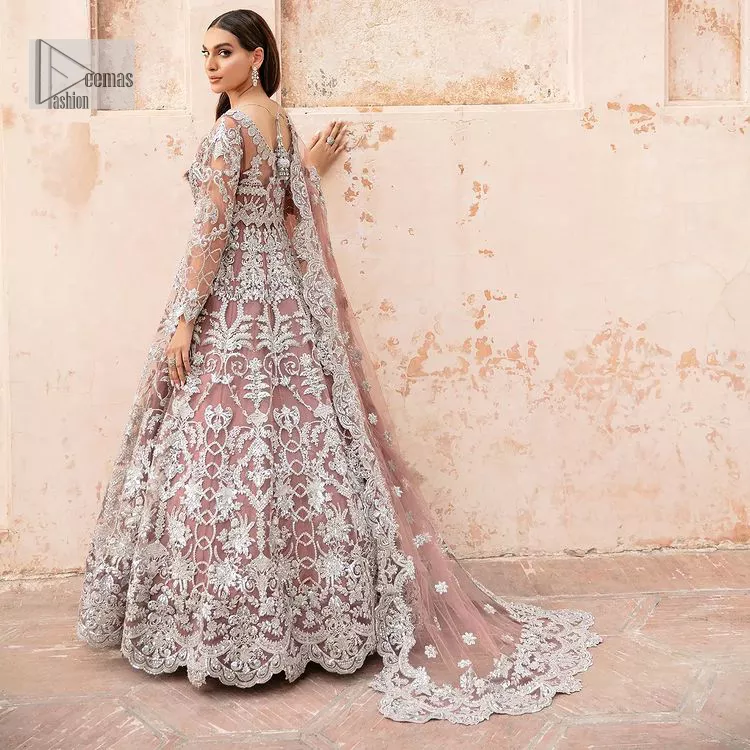 It’s regal, it’s rich, it’s festive. This magnificent nikah outfit is hand-embellished with luxury designs and beautiful silverwork which is highlighted with tilla, dabka, kora, Kundan and details of Zardozi. The boat shape neckline making this attire your foremost priority to wear on the most important day of your life. Further, the full sleeves of the blouse also decorated with beautiful embroidery It is coordinated with scalloped lehenga which is heavily embellished. Intricate designs and fine details of lehenga give a perfect finishing look to this masterpiece. Complete this outfit with dupatta in the same colour. The dupatta is in delicate heavy embellished border gives an exquisite look to the gorgeous bride. The scalloped borders of this dupatta give a stylish touch to this outfit.