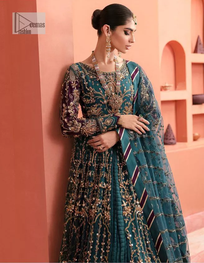 Mark your presence in this elegant Mehndi outfit. The front open scalloped pishwas in the teal green shade are adorned with hand-crafted details of tilla, dabka, Kora, Kundan and the real magic of Zardozi. It is further enhanced with golden embroidery to give a royal touch to this outstanding pishwas. The floral matters on full sleeves enhance the beauty of the outfit. In addition to this, the round neckline style of the following pishwas is absolutely breathtaking. It is paired with crushed lehenga n the same colour to enable the fairness of the outfit. Complete this stunning dress with a dupatta framed with a four-sided border to highlight your presence.