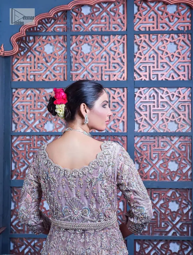 Tea Pink are always the hot trend for the walima outfit. Traditional designs and hand-crafted embellishments of the following maxi give a magnificent look to this perfect outfit. It is adorned with silver embroidery which involves tilla, dabka, Kora, Kundan and the real magic of crystals. The boat shape neckline has fine details and intricate designs. Further, the style of the three-quarter sleeves makes this masterpiece super stunning. It is paired with a lehenga in the same colour which is plain to balance the overall charm of the outfit. Finish this article with a dupatta which has an intricate embellished design on borders and sequins spray all over to make this dress a chic masterpiece.
