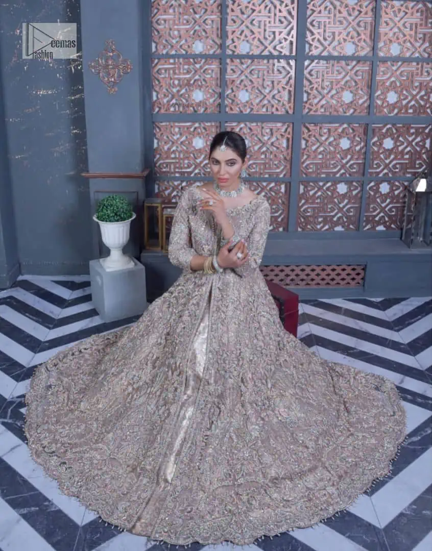 Tea Pink are always the hot trend for the walima outfit. Traditional designs and hand-crafted embellishments of the following maxi give a magnificent look to this perfect outfit. It is adorned with silver embroidery which involves tilla, dabka, Kora, Kundan and the real magic of crystals. The boat shape neckline has fine details and intricate designs. Further, the style of the three-quarter sleeves makes this masterpiece super stunning. It is paired with a lehenga in the same colour which is plain to balance the overall charm of the outfit. Finish this article with a dupatta which has an intricate embellished design on borders and sequins spray all over to make this dress a chic masterpiece.