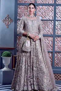 Tea Pink are always the hot trend for the walima outfit. Traditional designs and hand-crafted embellishments of the following maxi give a magnificent look to this perfect outfit. It is adorned with silver embroidery which involves tilla, dabka, Kora, Kundan and the real magic of crystals. The boat shape neckline has fine details and intricate designs. Further, the style of the three-quarter sleeves makes this masterpiece super stunning. It is paired with a lehenga in the same colour which is plain to balance the overall charm of the outfit. Finish this article with a dupatta which has an intricate embellished design on borders and sequins spray all over to make this dress a chic masterpiece.