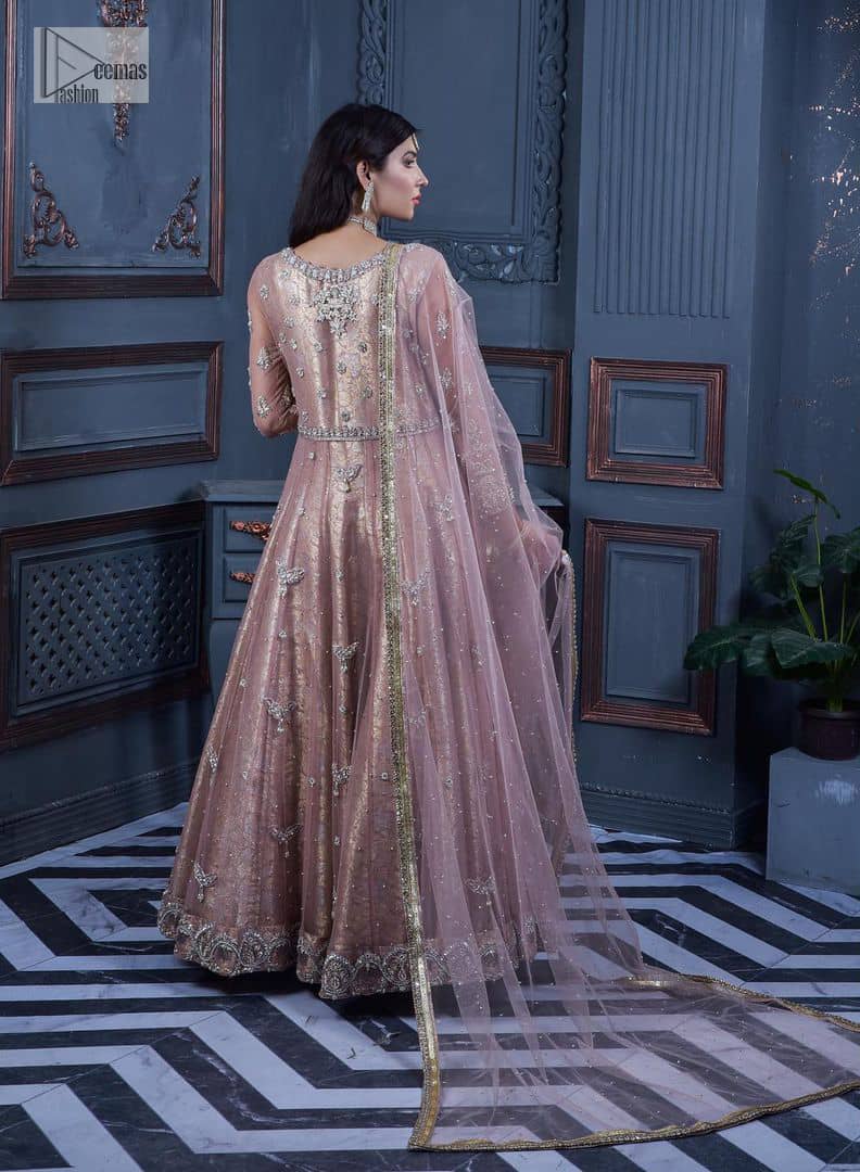 Have style and warmth with this tea rose nikah outfit! The front open maxi is the magic of floral motifs with engaging embellishments on the jamawar fabric, making this an eye-catching ensemble. The following maxi is adorned with tilla, dabka, Kora, Kundan and the real magic of Zardozi. The timeless silhouette is crafted, with floral motifs. The silver embellishments give a glamorous touch to this exquisite attire. In addition to this, the full sleeves are also decorated with floral motifs to make this article bright and charming. The round neckline also adds beauty to the overall look. Finish this article with a dupatta adorned with a four-sided borders and sequins sprayed all over for a perfect and classy look.