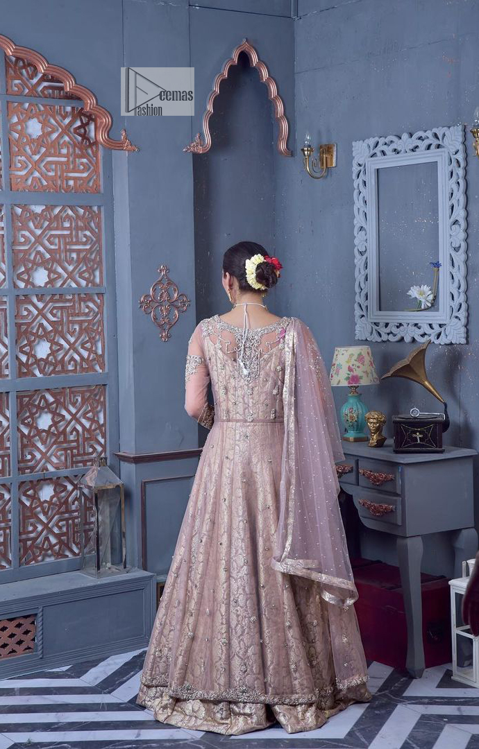 Create warm memories with this super soft and enticing tea rose nikah outfit. The vibrant shade of this maxi makes it an alluring choice for the bride. Hand-crafted adornments and designs which involve tilla, dabka, kora, Kundan and Zardozi make this attire an epitome of beauty and royalty. The round neckline of the following maxi is enhanced with silver and golden embroidery. Further, the sleeves are adorned with floral motifs to highlight the charms. The elaborately detailed border and sequin spray on the organza dupatta makes the costume ideal for your bug day.