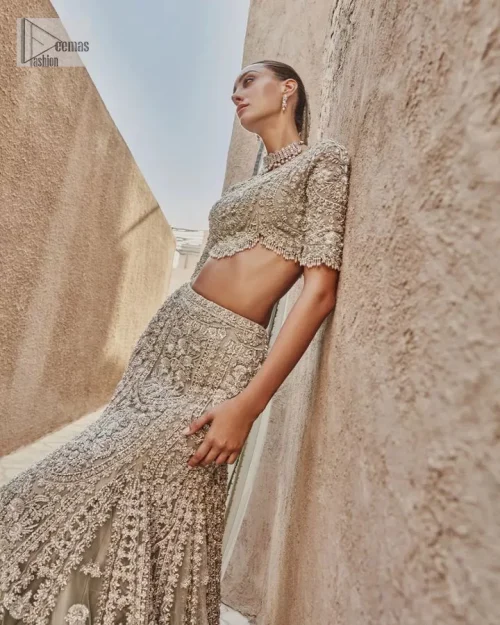 This fusion of floral embroidery is total fashion goodness for a walima outfit! A stunning teal grey organza choli embellished