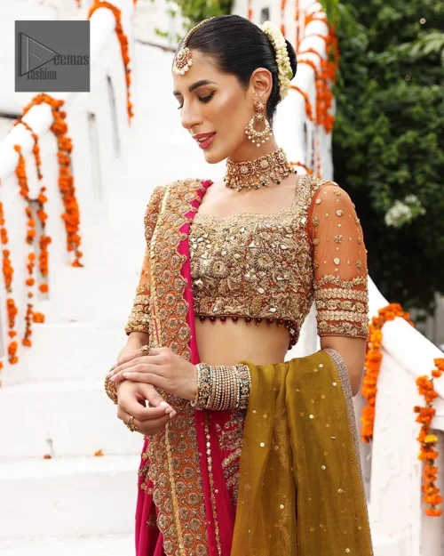 A rust blouse serves as a canvas for crystals, tilla, dabka, kora, Kundan, and the details of Zardozi.