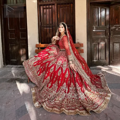 This unique red dress is a masterpiece of design, crafted with light golden and light antique shades of embroidery to