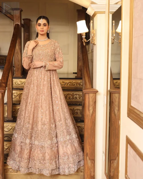 The luxurious Katan Banarsi Jamawar fabric envelops you in opulence while the embellished bodice glimmers with intricate silver and golden