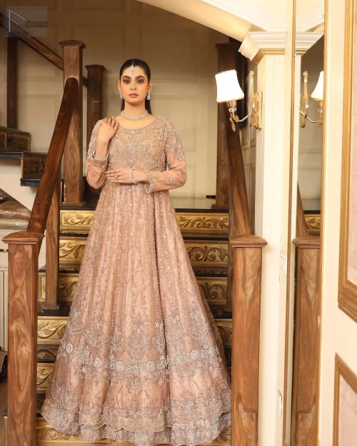 The full sleeves and round neckline offer a classic, regal appeal, while the scalloped hemline adds a whimsical touch.