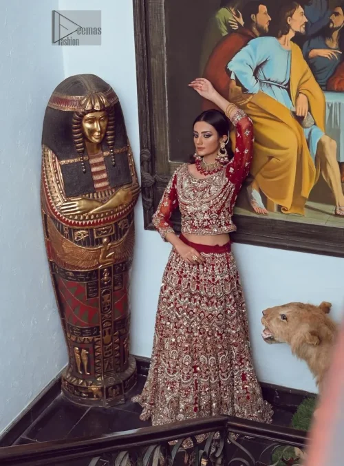 The blouse features a classic round neckline and elegant three-quarter sleeves, adding a touch of vintage charm.