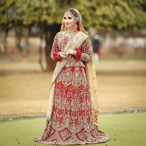 The striking lehenga, enhanced by voluminous Can Can layers, creates a dramatic silhouette, while the soft Fawn dupatta adds an