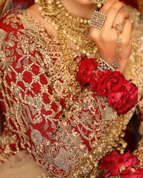 Exude splendour and charisma in this magnificent ensemble, an epitome of exquisite craftsmanship. Red Can Can Lehenga Blouse-Fawn Dupatta