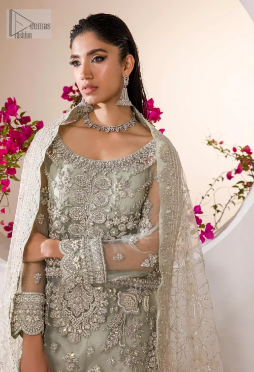 The long shirt, crafted from luxurious organza, flows effortlessly, accentuated by delicate silver embroidery that shimmers with every step.