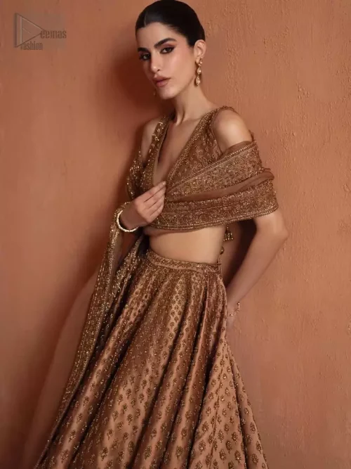 Side Profile: Side view of the bronze blouse and lehenga, highlighting the finished edges and concealed side zip fit.