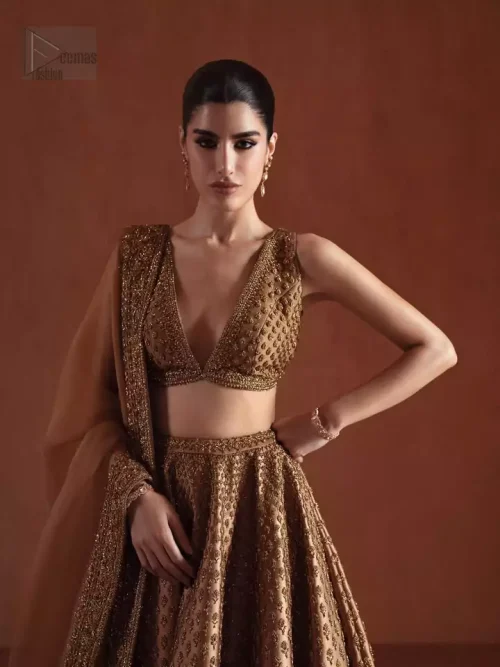 Movement Shot: The bronze lehenga in motion, showing the fluid drape of the pure silk and the weight of the