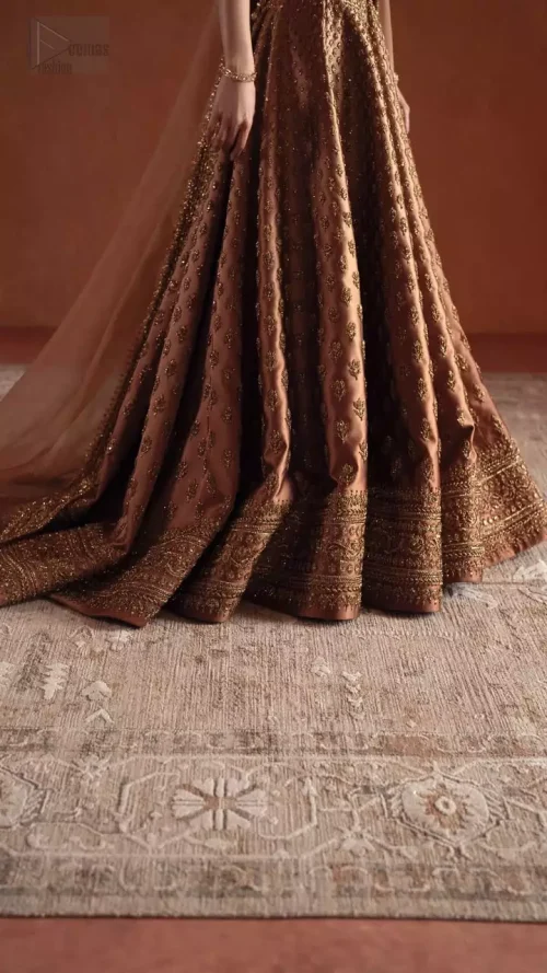 Back Silhouette: Elegant back profile of the bronze wedding attire showcasing the majestic back train and embellished choli.