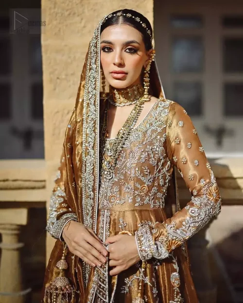 Radiant copper front-open maxi flowing over a delicately embroidered lehenga, a vision of festive opulence