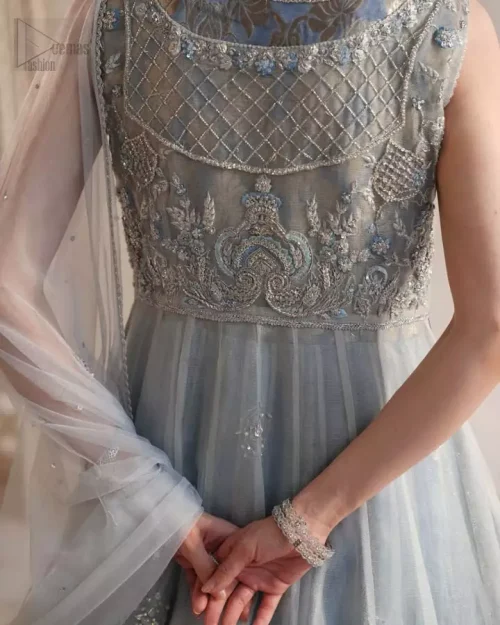 Ice blue couture piece with sheer layers and shimmering silver thread detailing