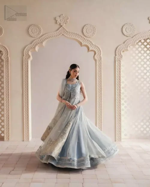 Softly cascading ice blue gown with refined embroidery and a modern feminine cut