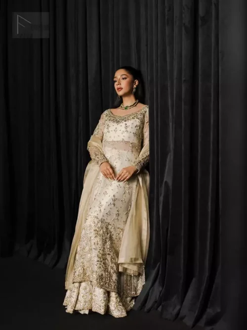 Luxurious organza fabric drapes beautifully, giving the long shirt and flowing sharara an ethereal, graceful appeal.