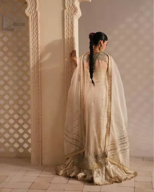 Refined ivory outfit featuring a sleeveless embroidered shirt and heritage-inspired flared sharara