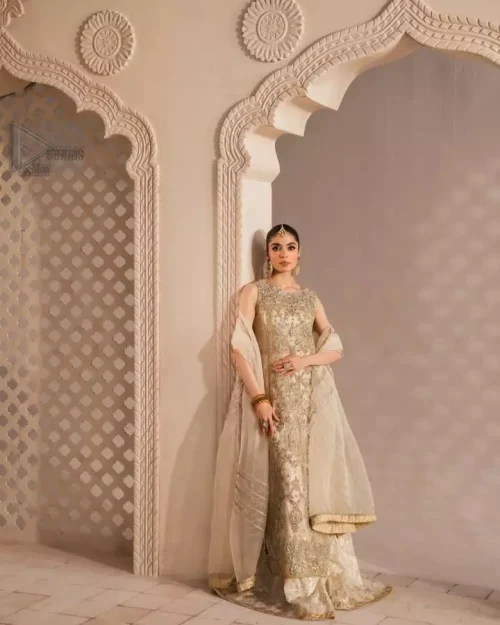 Delicately crafted ivory attire with luminous embellishments and an effortlessly flowing dupatta