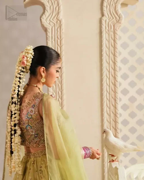 Blouse Craftsmanship: Close-up of the pink pure tissue blouse choli showcasing intricate multi-colour thread embroidery and light golden accents.