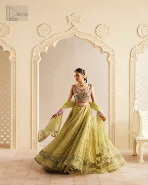 Heavily Embellished Hemline: A detailed look at the lime green lehenga's hemline featuring antique Boski shades, Dabka work, and stones.