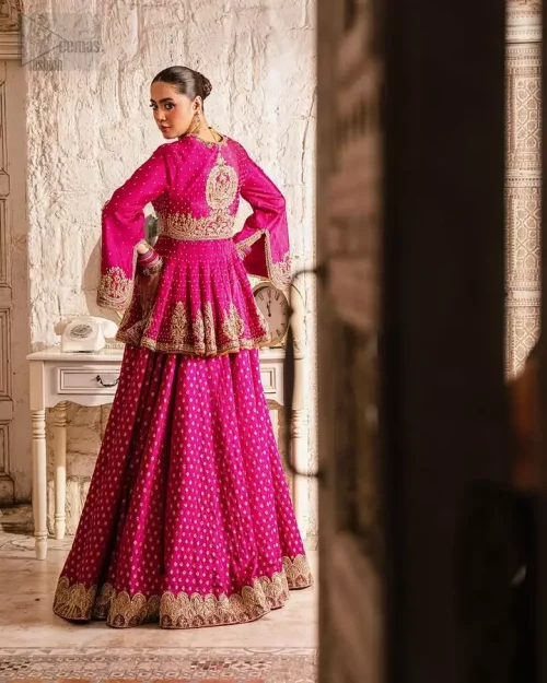 Lehenga Sprinkled Motifs: A focus on the tiny motifs sprinkled across the raspberry raw silk lehenga for an understated royal