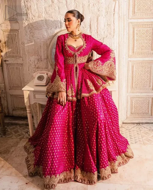 Crystal & Bead Work: Detailed shot of light-reflecting Swarovski crystals and stones on the raspberry bridal bodice.