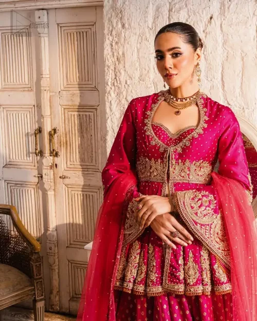 Sweetheart Neckline: Exquisite sweetheart neckline of the raspberry peplum, highlighted by intricate golden and antique embroidery.