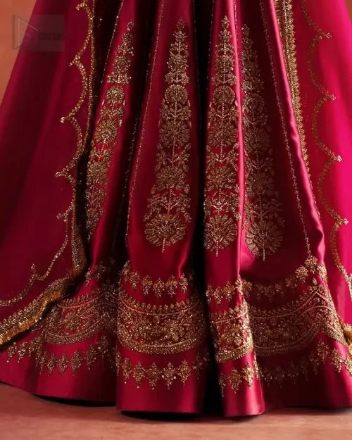 Hemline Craftsmanship: High-definition view of the heavily embellished lehenga bottom, highlighting premium Dabka and stone work.