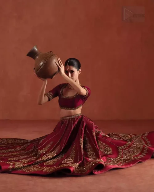 Waistline Precision: The fixed waist belt of the ruby red lehenga, showcasing the side zip closure and seamless finishing.