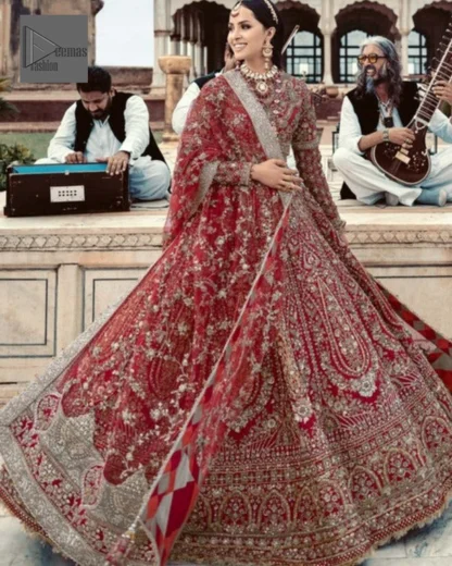 Make your day bright and bold! Deemas Fashion presents a beautiful red outfit which involves silver embroidery and is covered with tilla, dabka, kora, Kundan and the beautiful details of Zardozi. The full sleeves are covered with attractive floral patterns. Further, the jewel neckline gives a romantic touch to this beautiful outfit. The?Bridal Lehenga?has a massive flare and it gives the gorgeous bride a breathtaking look on the big day.?The Lehenga is gracefully emblazoned with?sequins, crystals, and Resham. Intricate details of zardozi and gota make this Lehenga Dress an epitome of grace. A beautiful dupatta with floral patterns & beautiful embellished border completes the look. Top: Blouse Colour: Red Fabric: Organza Fully Embellished Jewel Neckline Silver Embroidery Full-Length Sleeves Floral Patterns Concealed With Side Zip Finished Edges Bottom: Lehenga Colour: Red Fabric: Organza Fully Embellished Flared Finished Edges Fixed Waist Belt With Side Zip Closure Dupatta: Colour: Red Fabric: Net Floral Patterns Dupatta Having Four Sides Embellished Border Finished Edges Embellishment : Work includes kora, dabka, stones, sequins, beads, silk threads and Swarovski crystals. 100% pure highest quality imported fabric.
